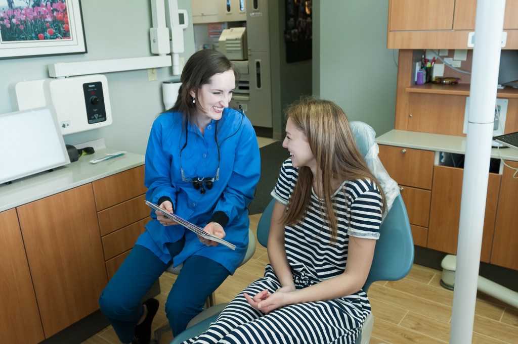 Dentist Dr. Hernon talking with her patient